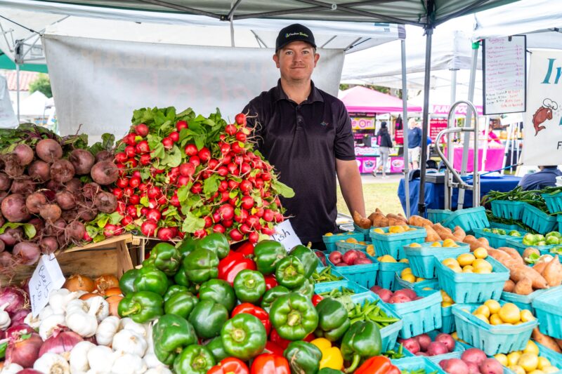 Local Florida produce at a farmers market being sold by farmer